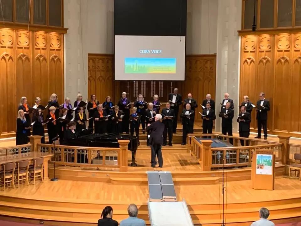 Cora Voce | Choir performing in a church during a live musical performance.
